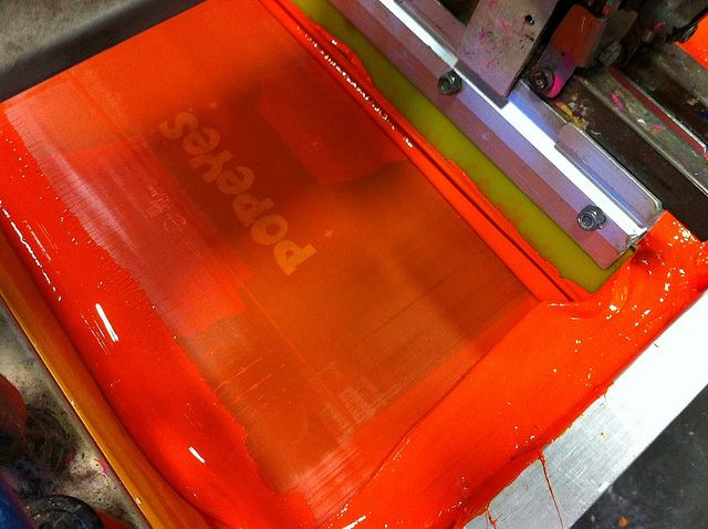 Ink in tray being pressed on product