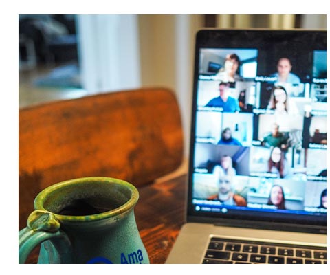 Laptop with Green Coffee Mug Sitting in Front of It